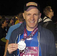 Photo of Stewart holding his medal