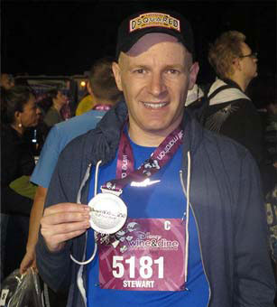 Photo of Stewart holding his medal