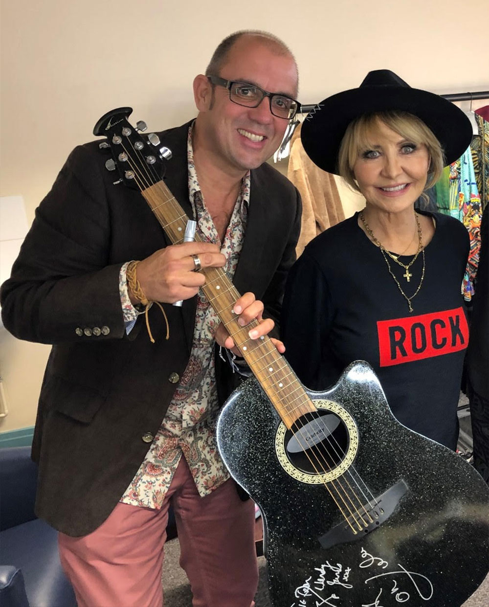 Jools Holland, Lulu and signed guitar Man and lady holding signed guitar