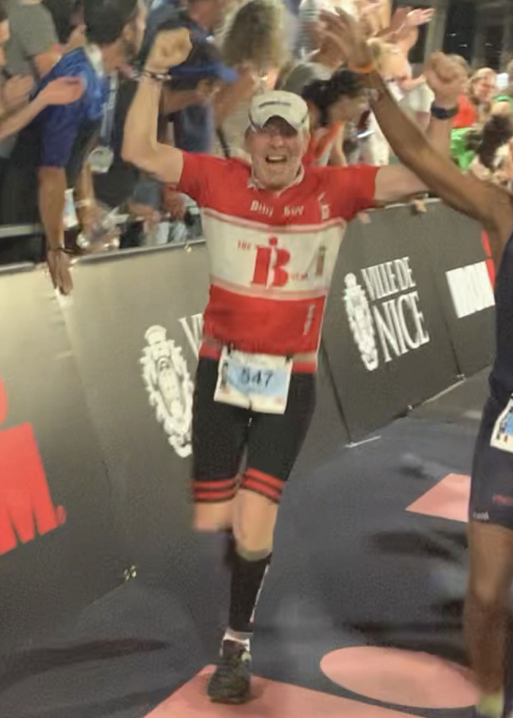 Man in cycling gear running and cheering
